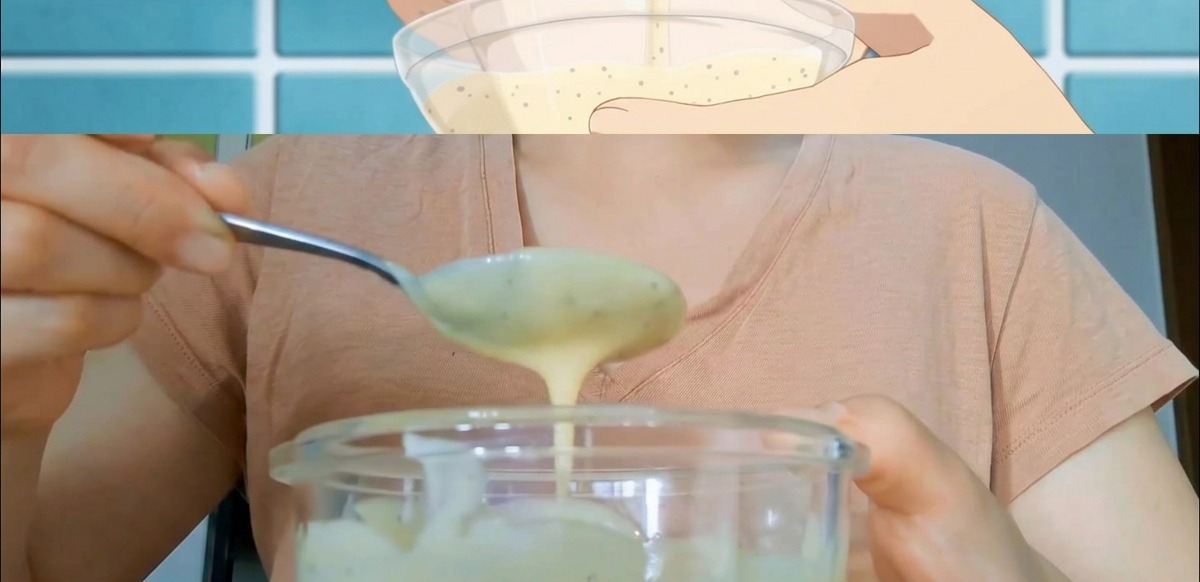 Hände rühren eine cremige Sandwichsauce in einer Glasschüssel mit einem Metalllöffel an.