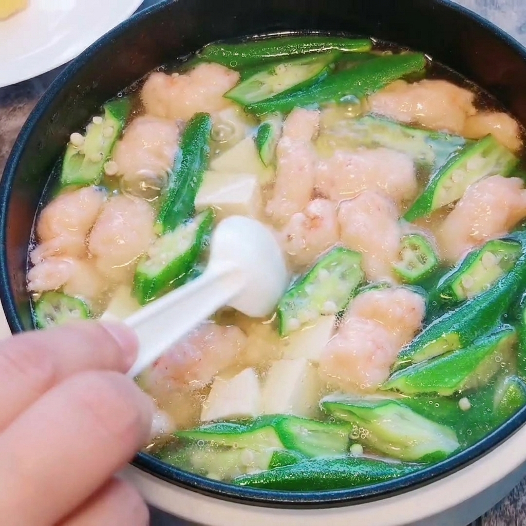 Salz und weißer Pfeffer werden in die fertige Suppe gegeben.