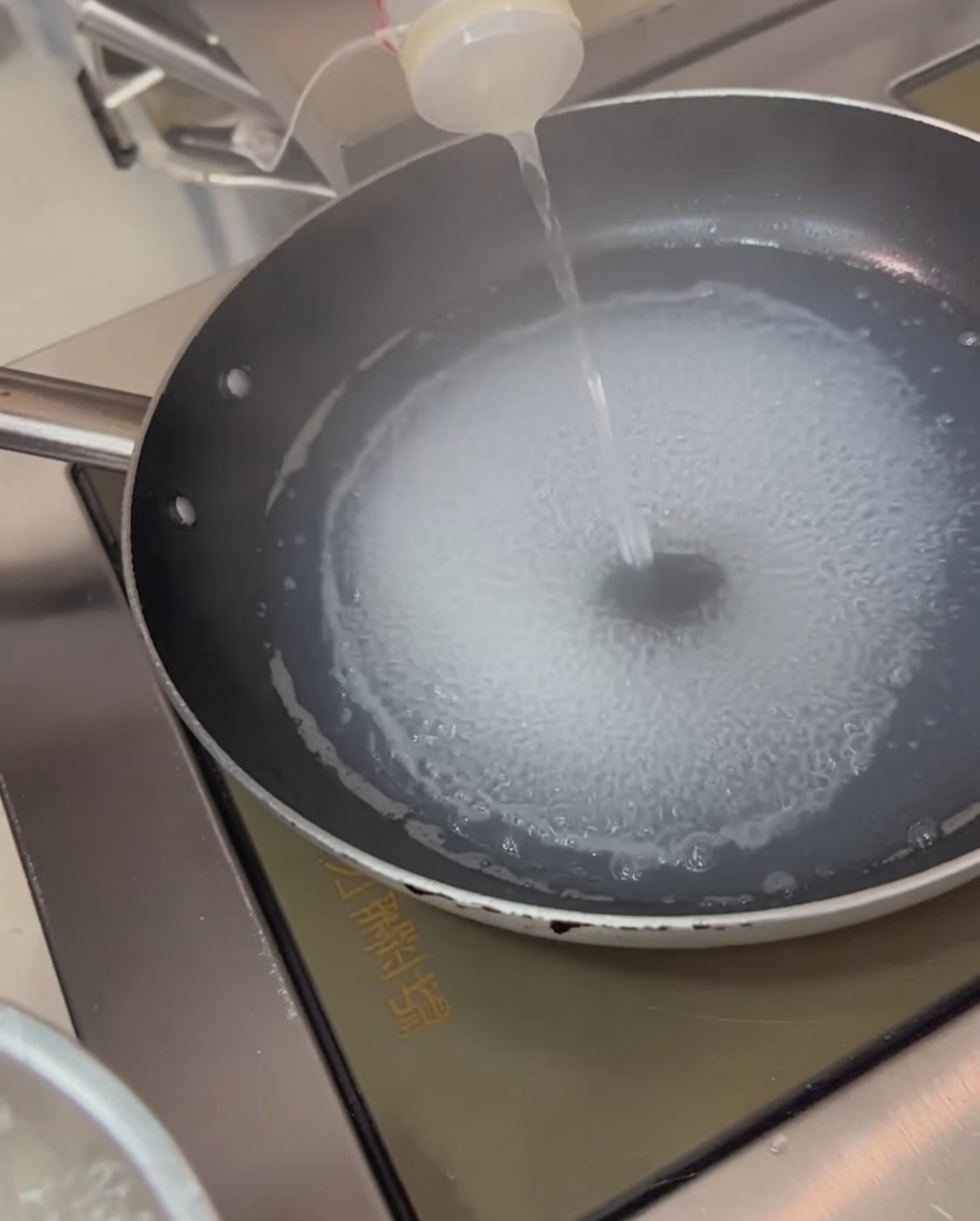 Tintenfischringe werden in kochendem Wasser blanchiert.