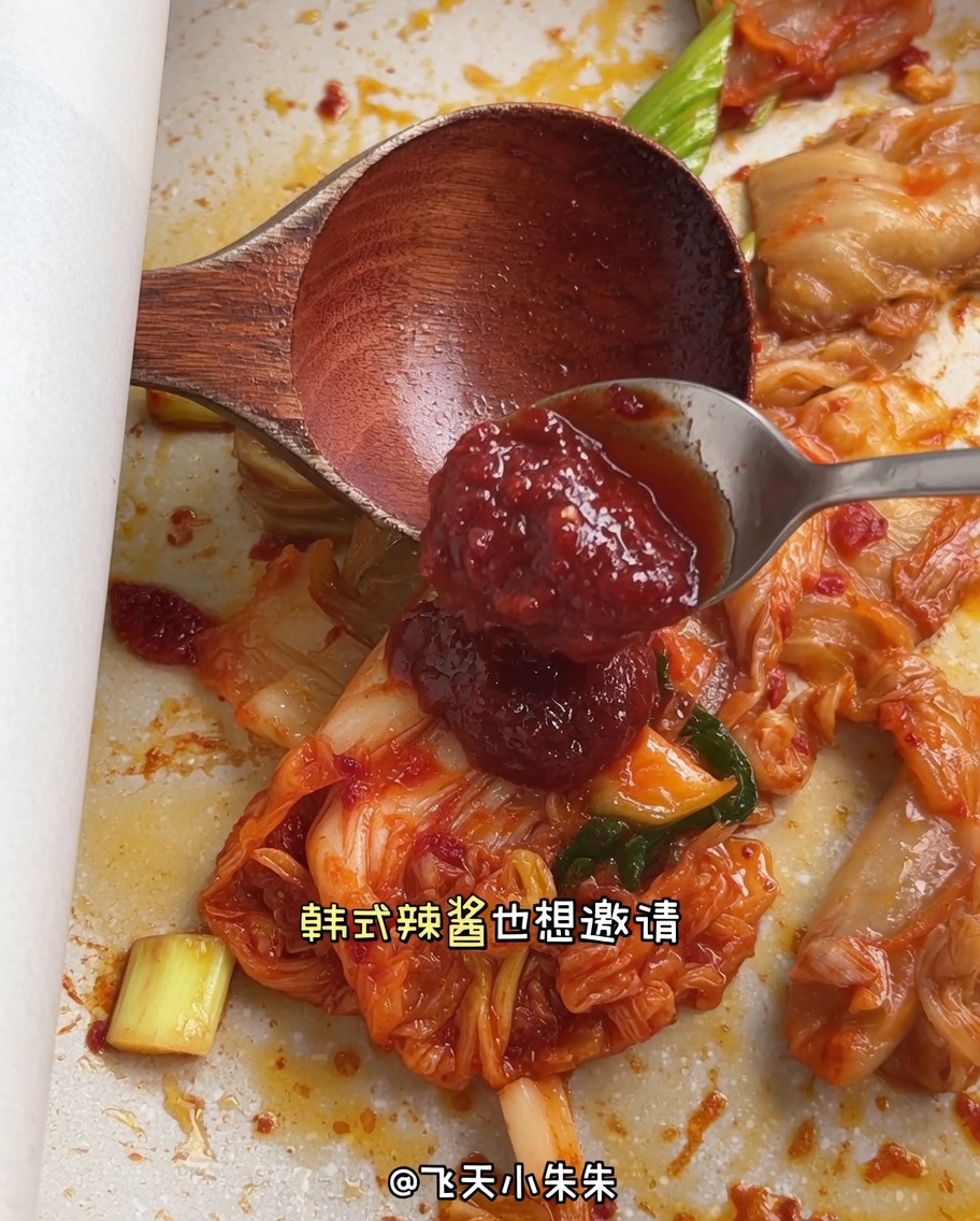 Ein Löffel rote koreanische Chilipaste wird in die Pfanne gegeben.