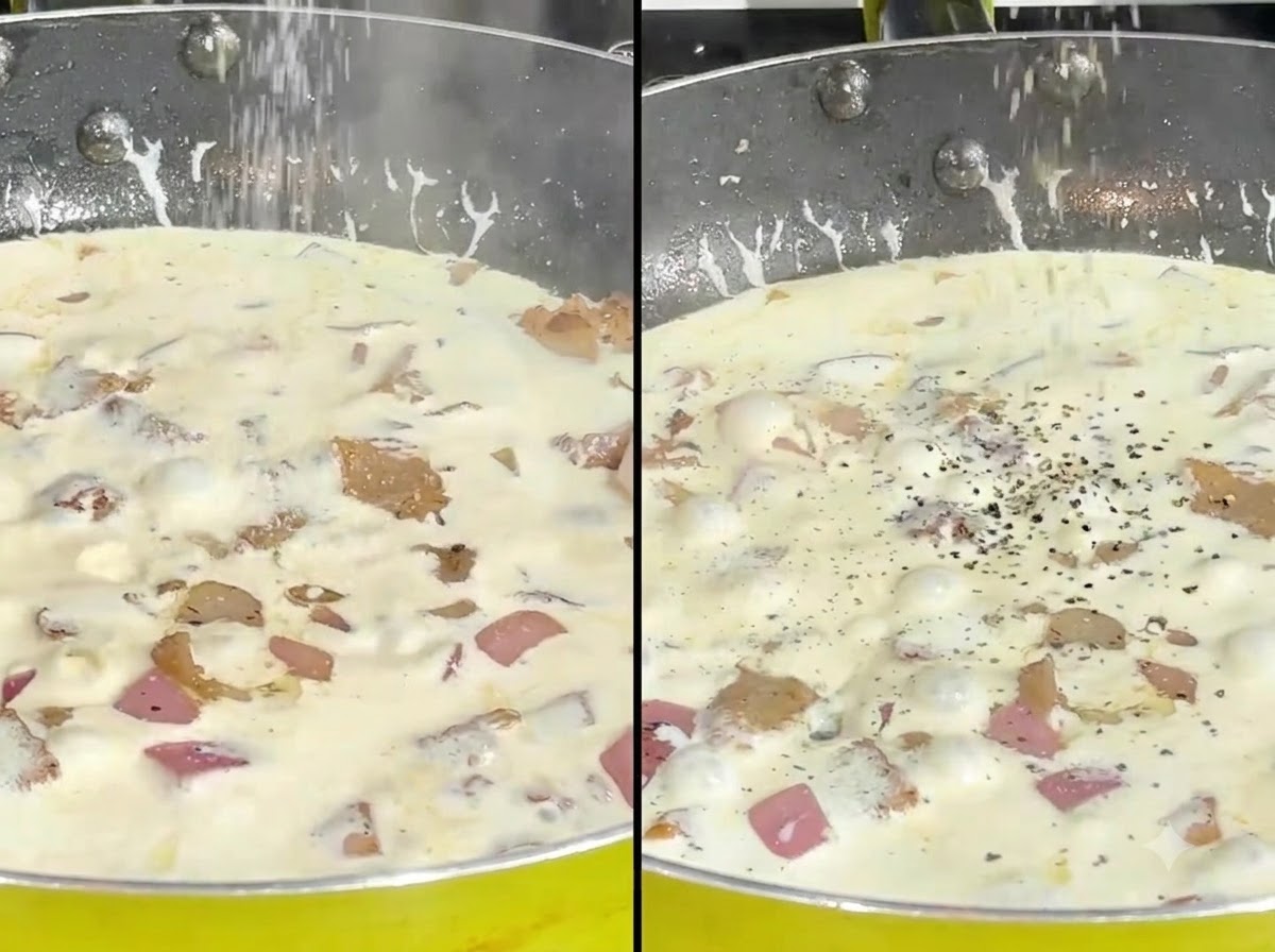 Salz und gemahlener schwarzer Pfeffer werden über eine köchelnde Cremesauce in einer Pfanne gestreut.