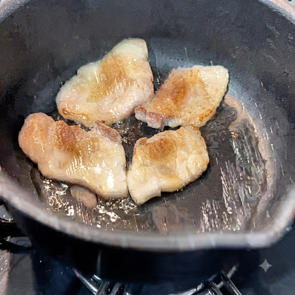 Wasser wird in den heißen Topf mit angebratenen Schweinebauchscheiben gegossen.
