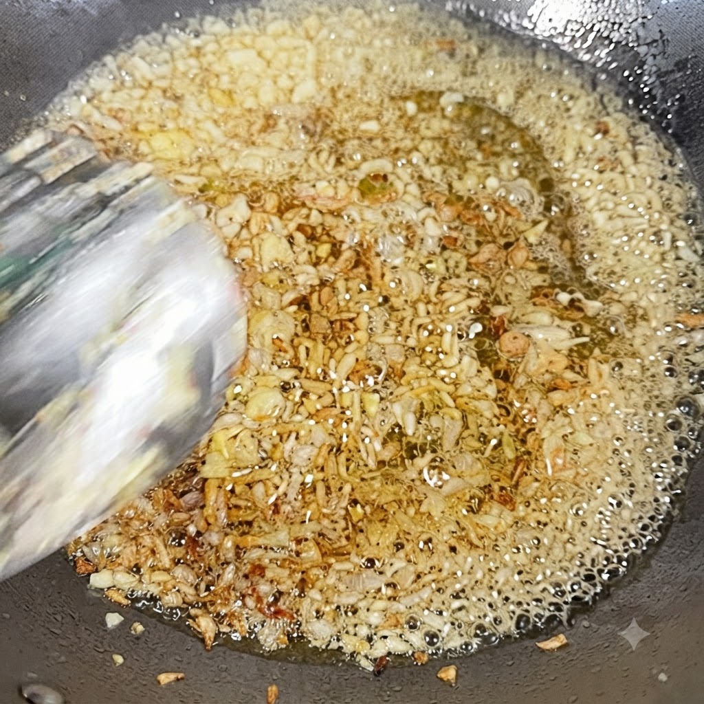 Gehackter Knoblauch und gewürfelte Zwiebeln braten in heißem Öl in einem Wok.